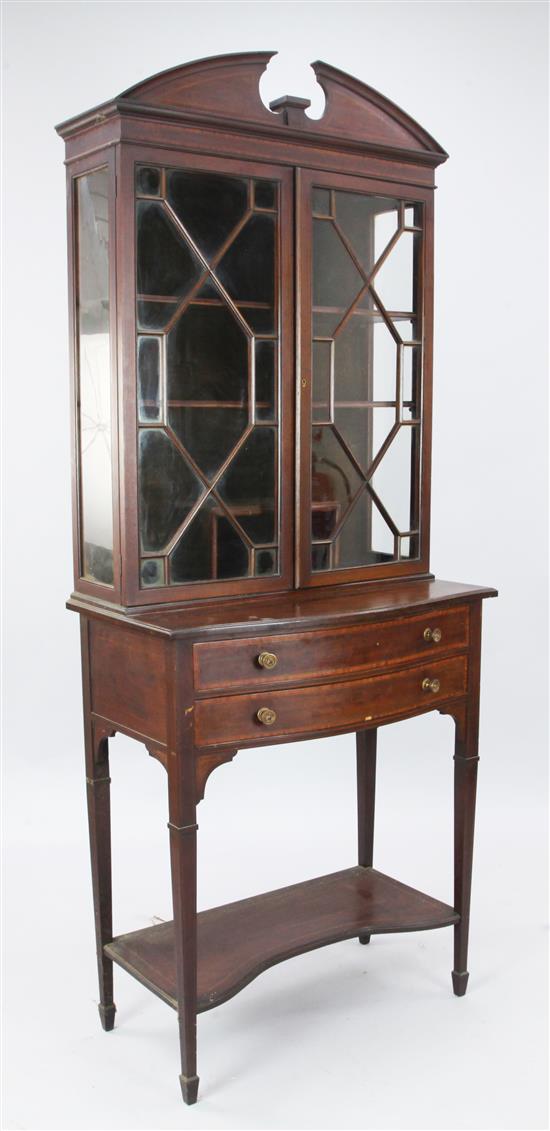 An Edwardian crossbanded mahogany display cabinet on stand, W. 2ft 6in. D. 1ft 5in. H. 6ft 4in.